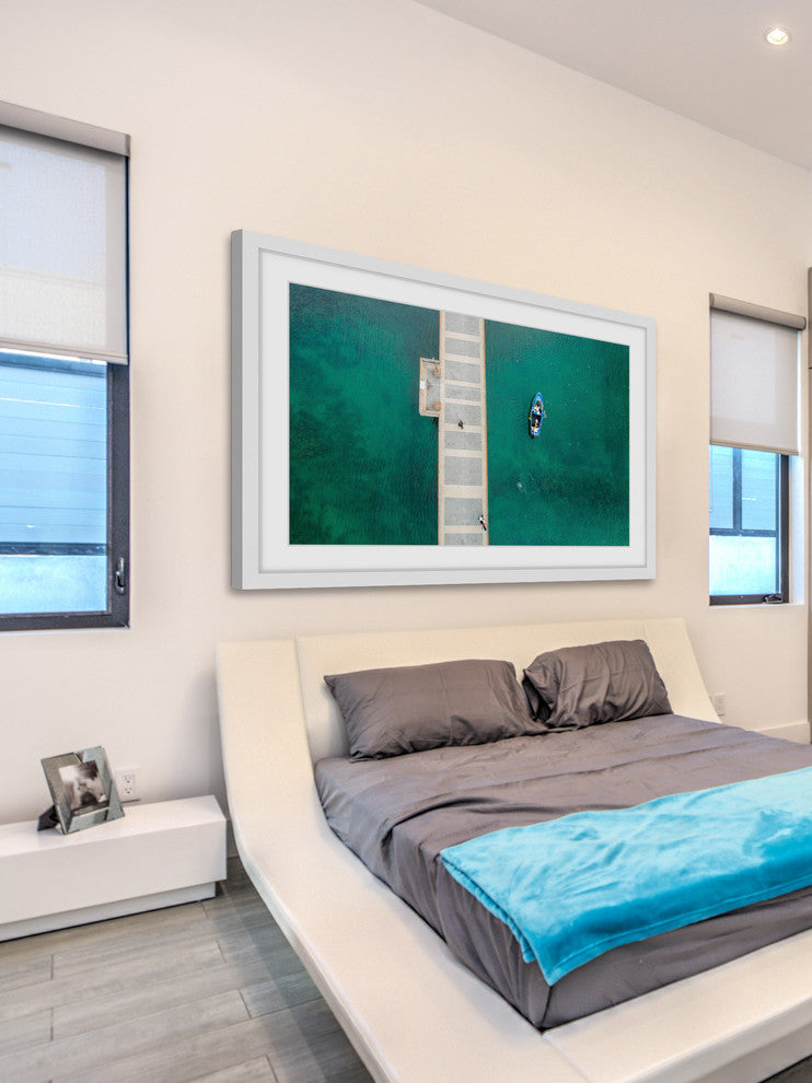 "Floating Blue Boat" Framed Print by Karolis Janulis