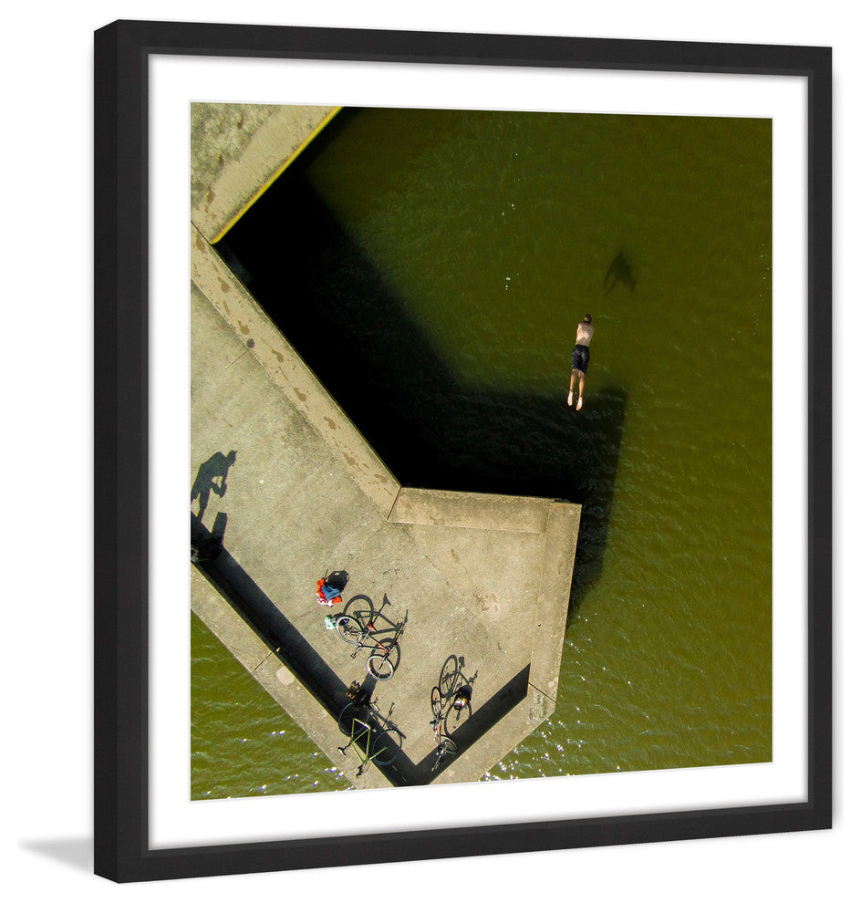 "Bikes On The Pier" Framed Print by Karolis Janulis