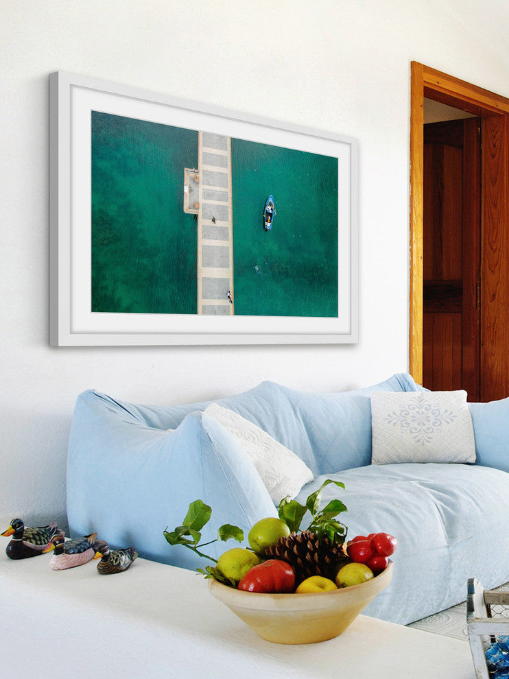 "Floating Blue Boat" Framed Print by Karolis Janulis