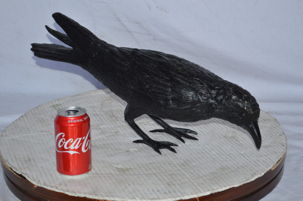 Raven with his head down Bronze Statue - Size: 22"L x 6"W x 11"H.