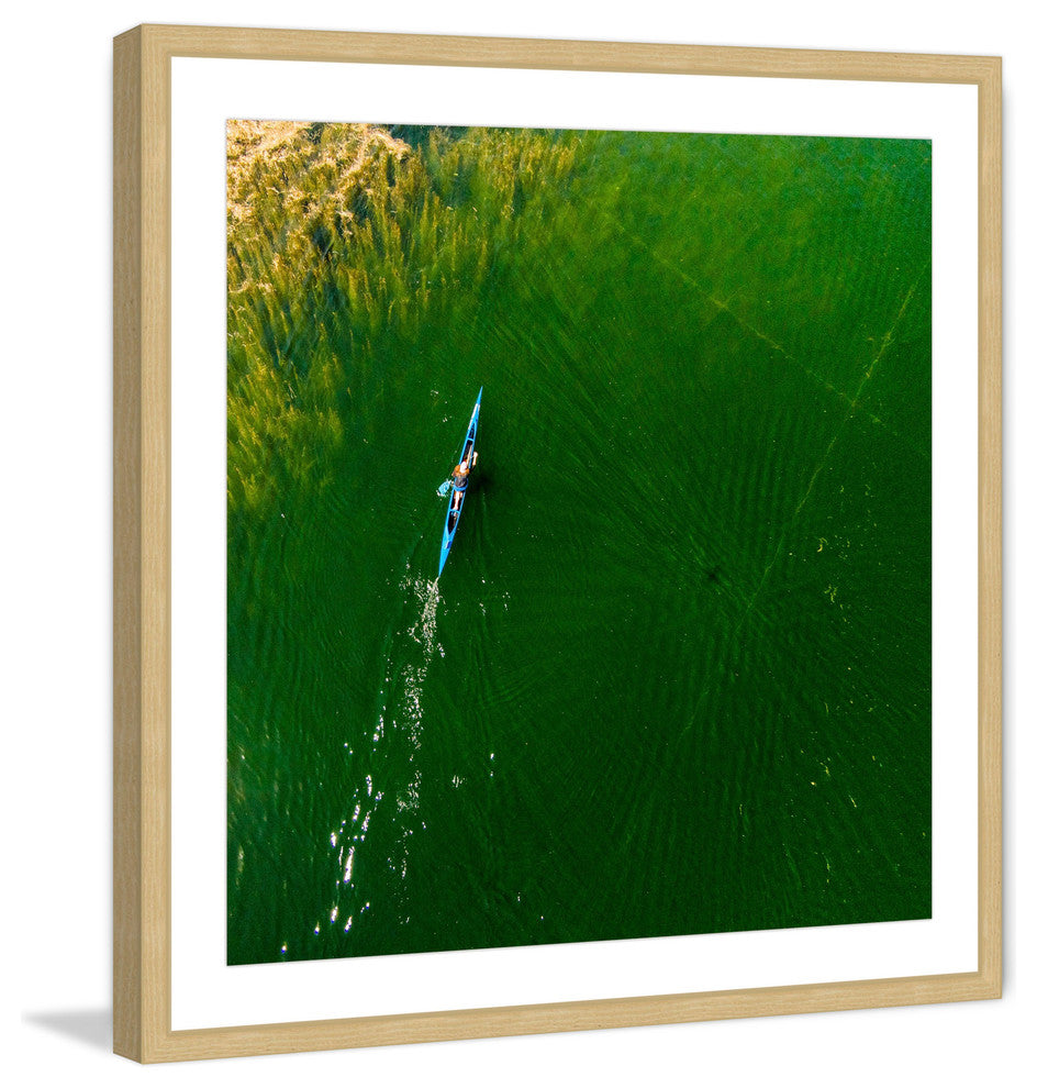 "Blue Canoe" Framed Print by Karolis Janulis