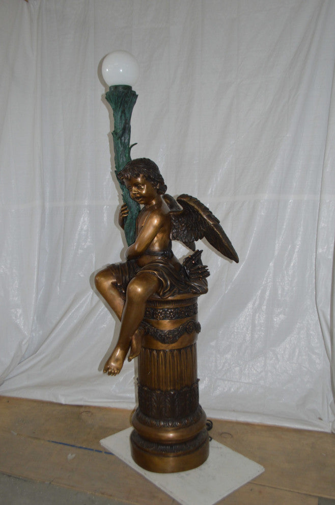 Pair of Cupid on stand lamp -  Size: 28"L x 24"W x 90"H.
