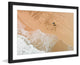 "Lapping The Sand" Framed Print by Karolis Janulis