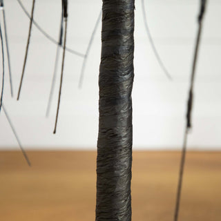 Close-up of trunk in a lifestyle setting; wires visible.