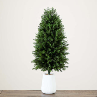 Lifestyle image showing the tree in a decorative setting with planter.