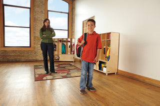 Lifestyle shot with a child near the unit in a room; product visible.
