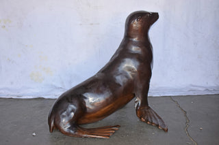 Perched Life Size Seal bronze statue - Size: 40"L x 35"W x 31"H.