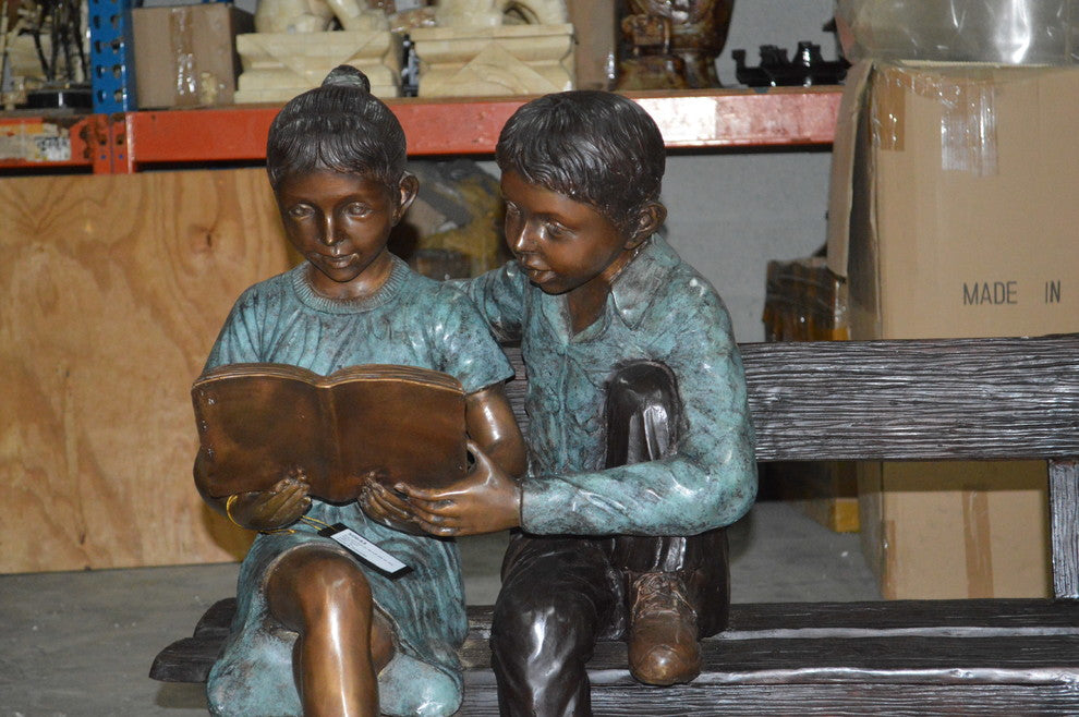 Boy and a Girl on Bench reading book bronze Statue -  Size: 43"L x 20"W x 36"H