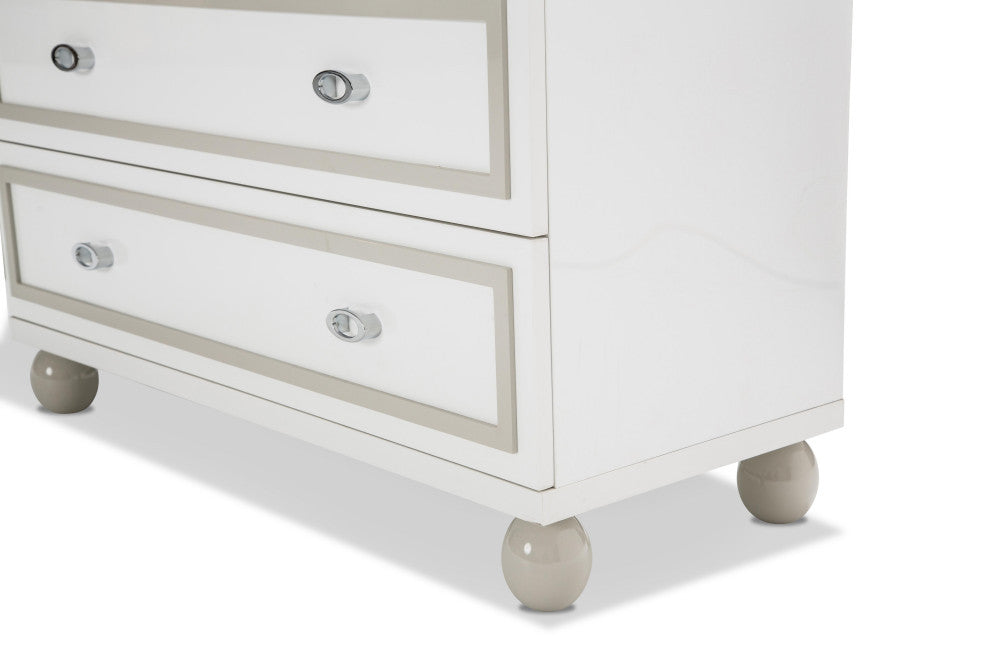 Angled close-up of lower drawers and feet on white background (detail).