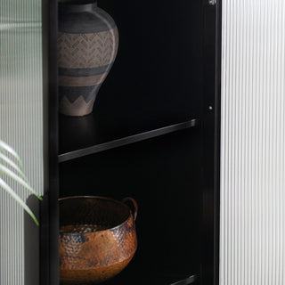 Interior shelf detail with decor; cropped view inside cabinet
