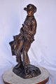 Cowboy Holding His Saddle Bronze Statue - Size: 20"L x 14"W x 35"H.