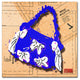 'Bow Purse White on Blue' Canvas Art by Roderick Stevens