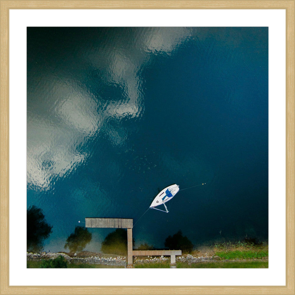 "Lone White Boat" Framed Print by Karolis Janulis