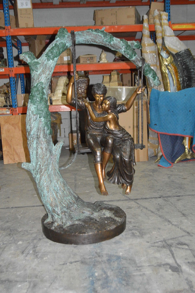 Lovers on a Swing Bronze Statue -  Size: 48"L x 32"W x 64"H.