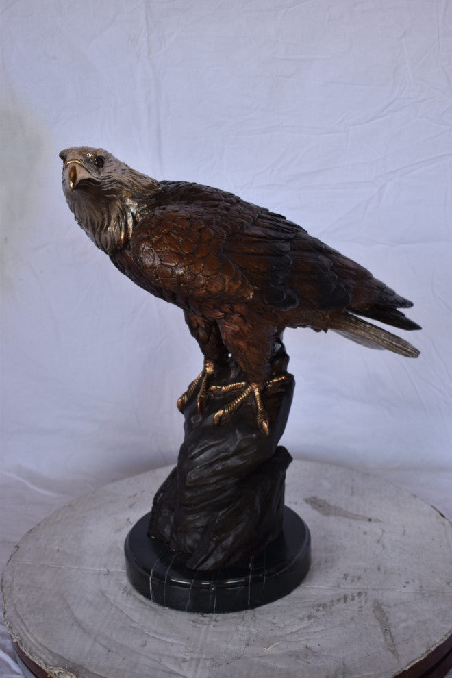 Eagle on Rock Bronze Statue Mounted on Marble Base Size: 10"L x 22"W x 21"H.