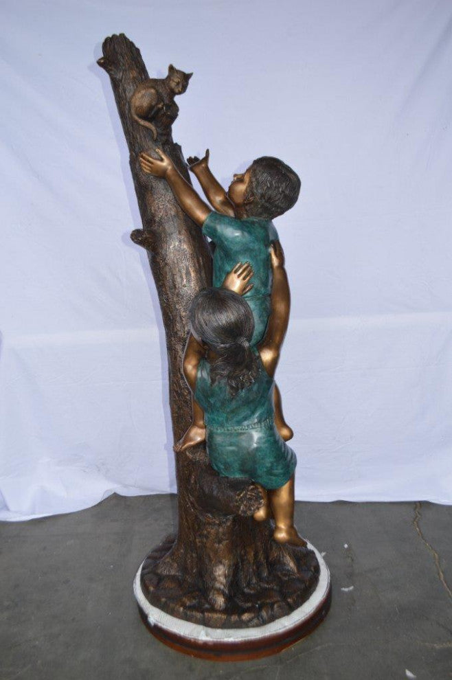 Children reaching up tree for a cat bronze statue -  Size: 24"L x 21"W x 64"H.