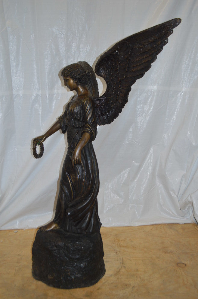 Angel Standing on a Rock Bronze Statue -  Size: 60"L x 36"W x 71"H.