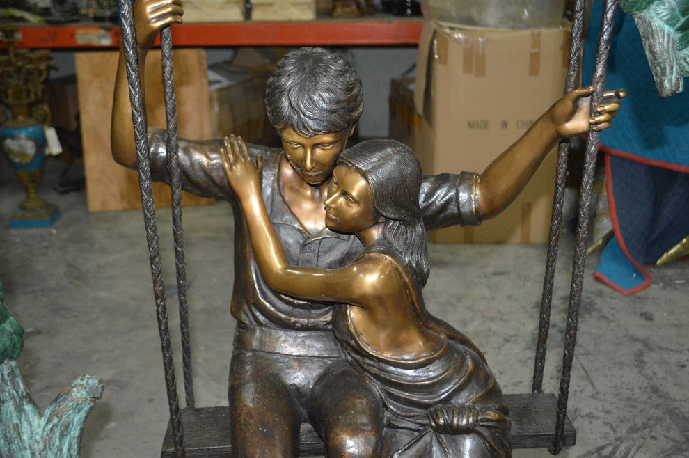 Lovers on a Swing Bronze Statue -  Size: 48"L x 32"W x 64"H.