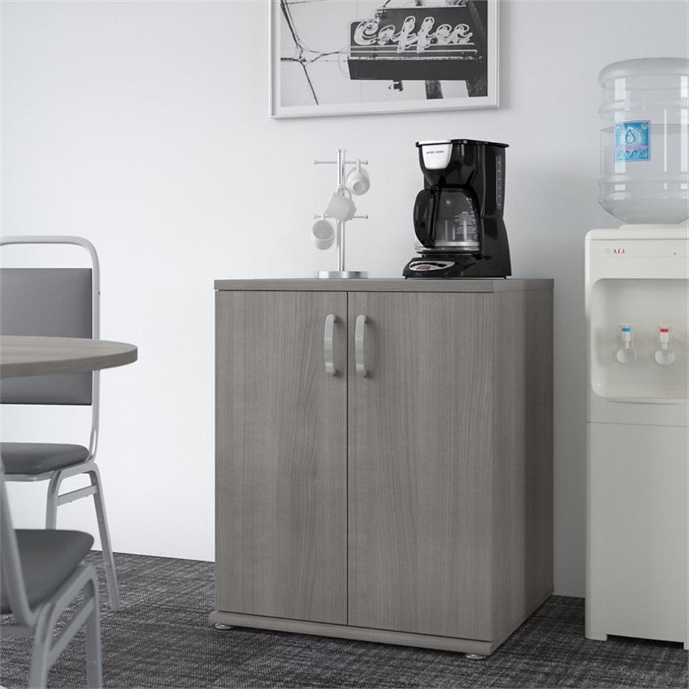 Lifestyle shot showing the cabinet in a real environment with a coffee station nearby.