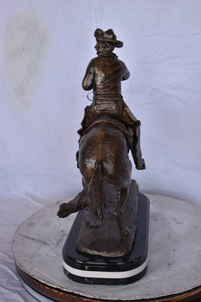 Remington Cowboy Replica Bronze Statue on Triple Marble Size: 8"x 26"x 23"H.