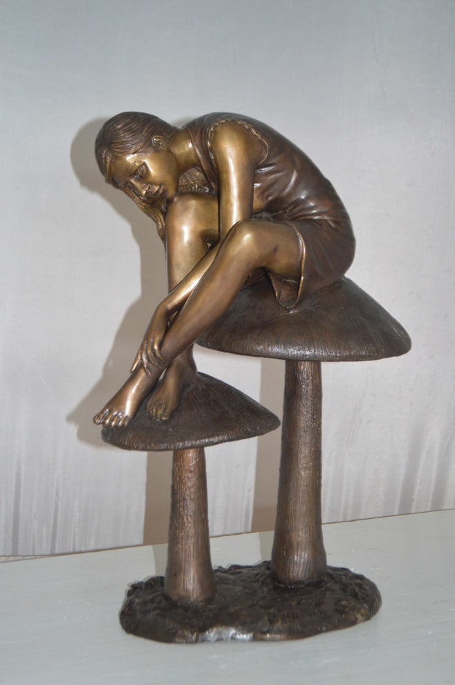 Girl sitting on Mushrooms Bronze Statue -  Size: 13"L x 11"W x 18"H.