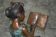 Girl with Glasses on Bench  Bronze Statue -  Size: 43"L x 20"W x 36"H.