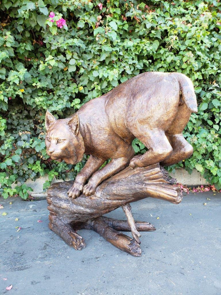 Bobcat Going Down a Tree Log Bronze Statue -  Size: 43"L x 25"W x 41"H.