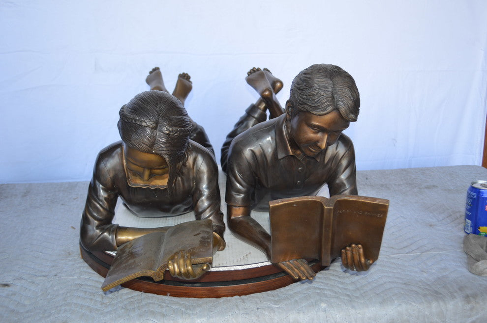 A Set of Boy and Girl Reading Books Bronze Statue -  Size: 31"L x 10"W x 14"H.