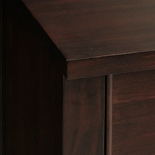 Close-up of drawer knob on wood surface.