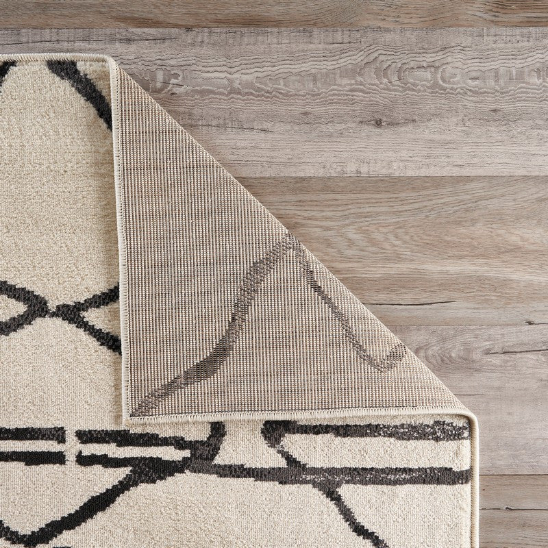 5" x 7" Cream and Black Distored Berber Area Rug
