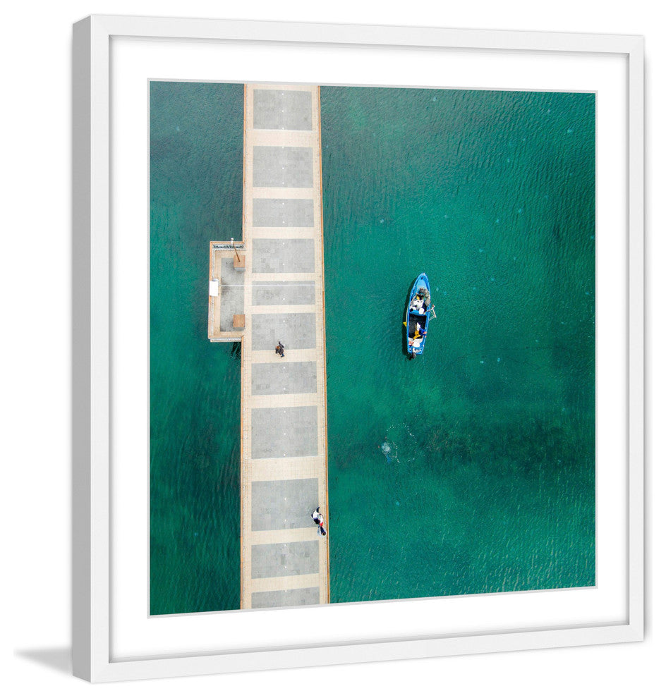 "Blue Boat Floats" Framed Print by Karolis Janulis