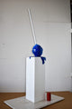 Blue Lollipop Mounted on A White Pedestal Resin Statue Size: 10" x 10" x 59"H