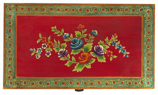 Close-up of decorative floral panel on red background, cropped.