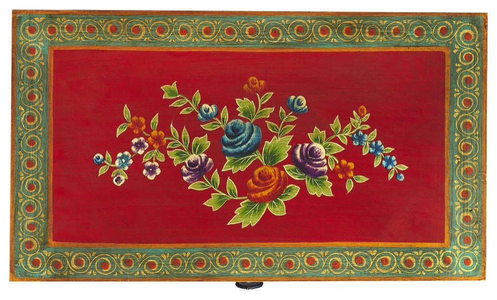 Close-up of decorative floral panel on red background, cropped.