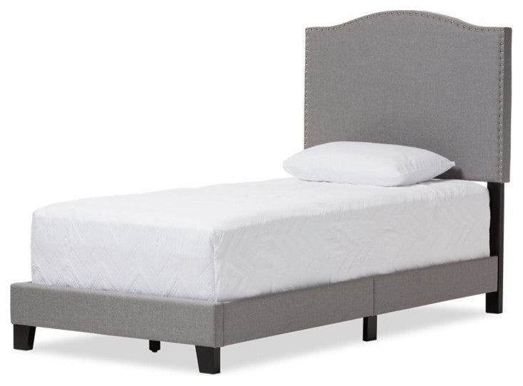 Full front-facing/dominant view of the bed showcasing the arched headboard and gray fabric.
