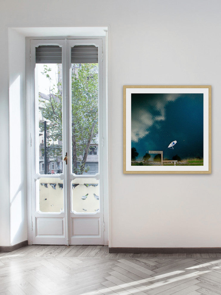 "Lone White Boat" Framed Print by Karolis Janulis