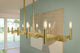 Erzo 50" 10 Light Linear Chandelier, Natural Brass