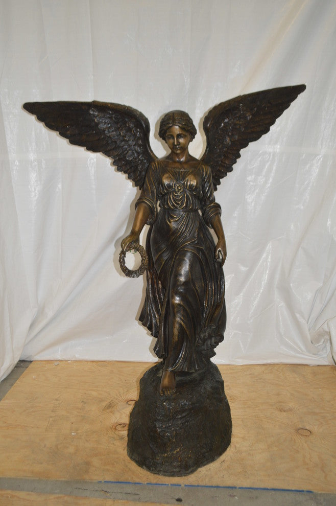 Angel Standing on a Rock Bronze Statue -  Size: 60"L x 36"W x 71"H.