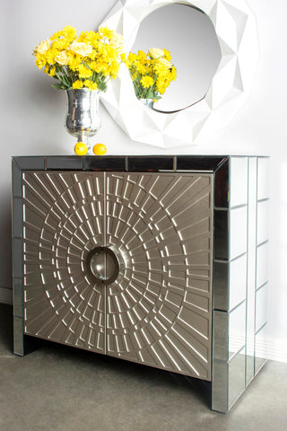 Lifestyle image featuring the cabinet in a room with decor (mirror behind); full product visible.