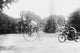 Motorcycle Cop Chases a Penny Farthing Velocipede Down a DC Street with Washingt