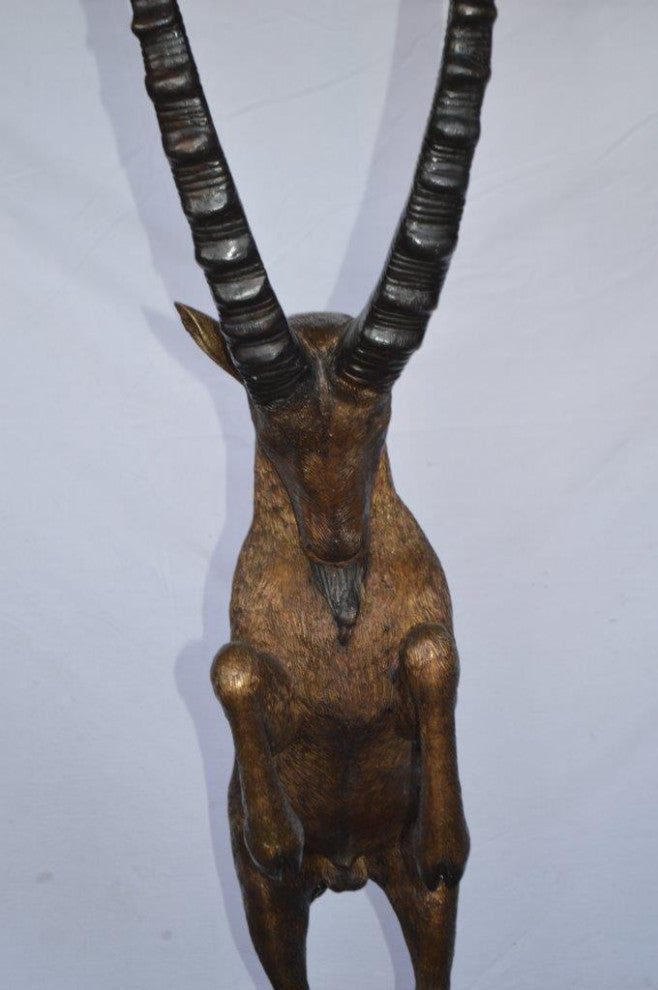Mountain goat on hind legs bronze statue -  Size: 36"L x 16"W x 66"H.