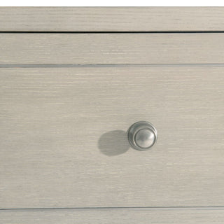 Close-up of top drawer fronts on white background; cropped view focusing on detail.