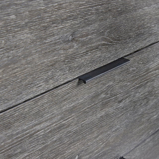 Close-up of wood grain and drawer handle on white background.