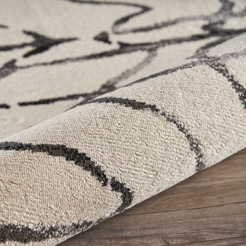 5" x 7" Cream and Black Distored Berber Area Rug