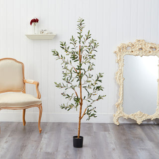 Lifestyle image showing the artificial olive tree in a room setting.