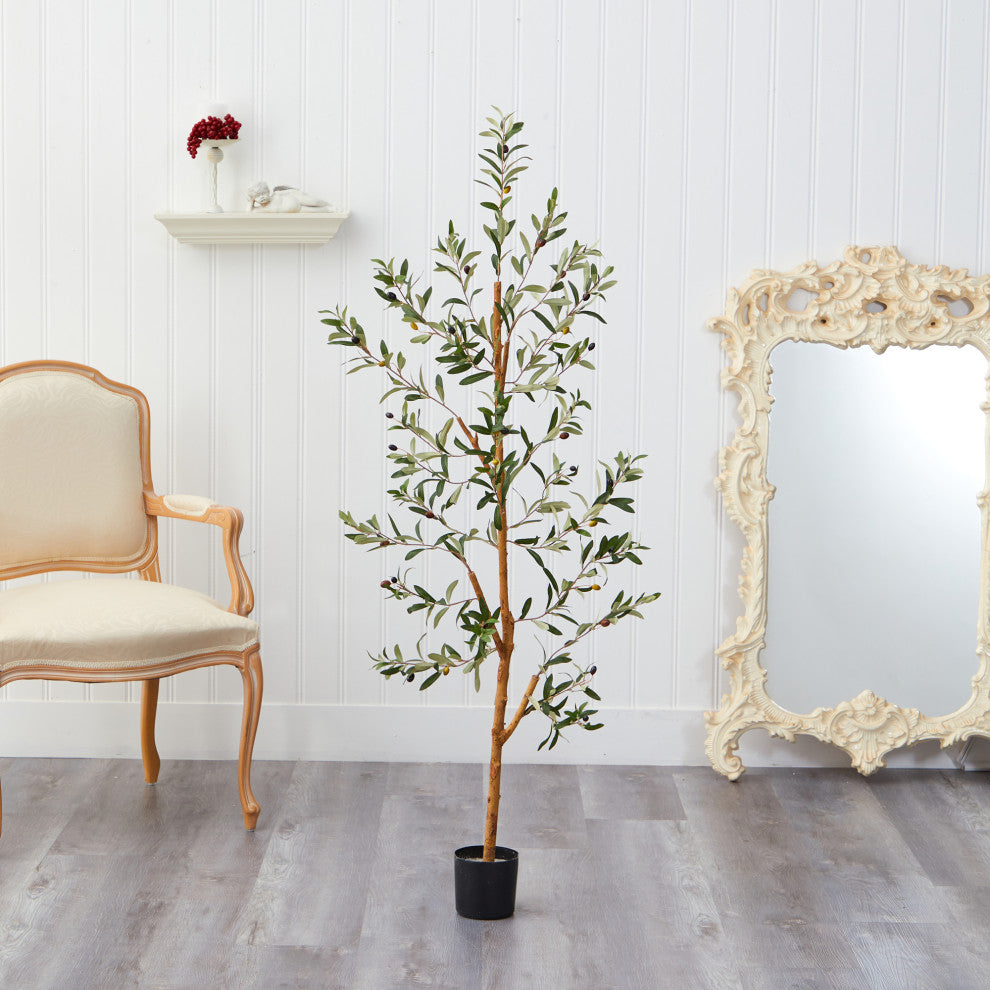 Lifestyle image showing the artificial olive tree in a room setting.