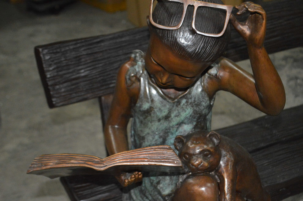 Girl with Glasses on Bench  Bronze Statue -  Size: 43"L x 20"W x 36"H.