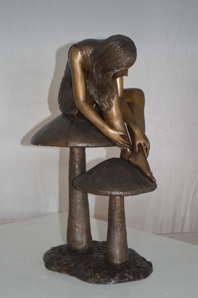 Girl sitting on Mushrooms Bronze Statue -  Size: 13"L x 11"W x 18"H.