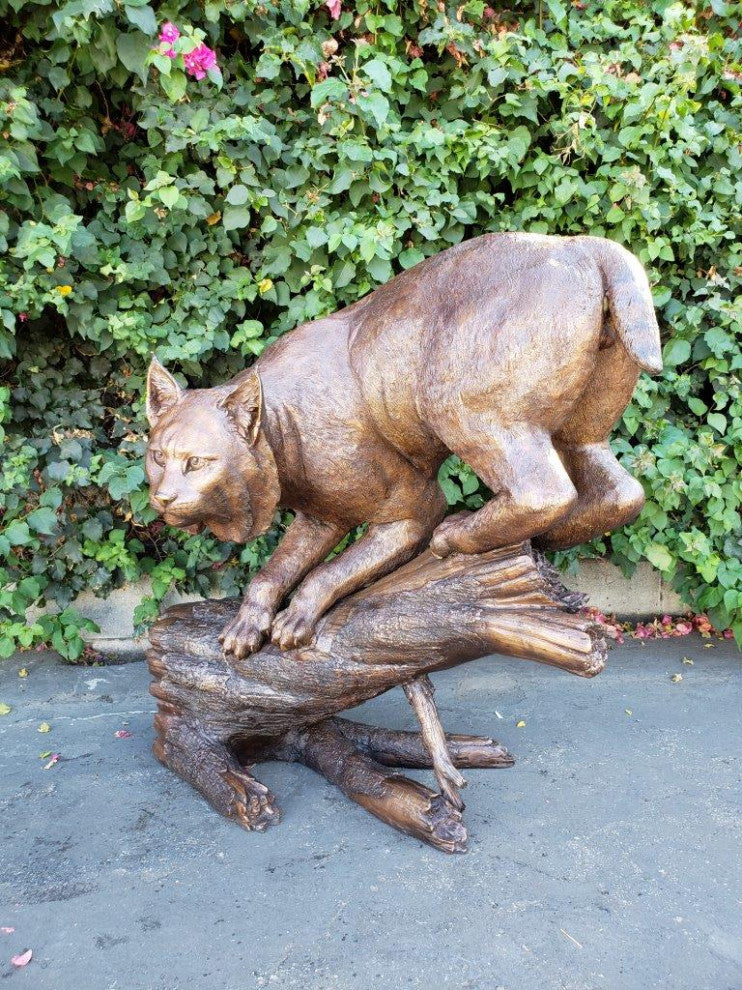Bobcat Going Down a Tree Log Bronze Statue -  Size: 43"L x 25"W x 41"H.