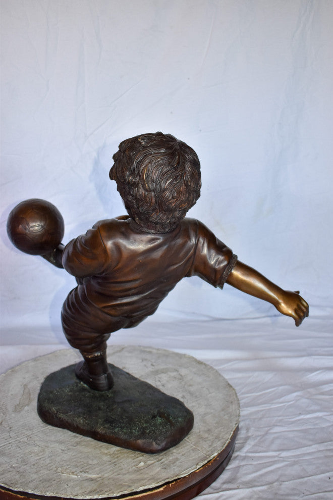 Young Boy Passionately Kicking Soccer Ball Bronze Statue  Size: 26" x 16" x 24